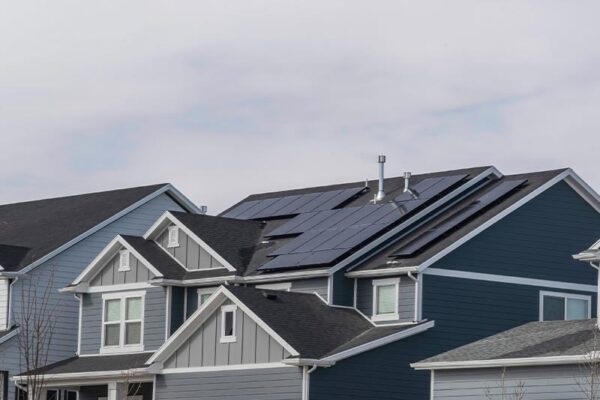 two story home in a neighborhood with solar panels installed