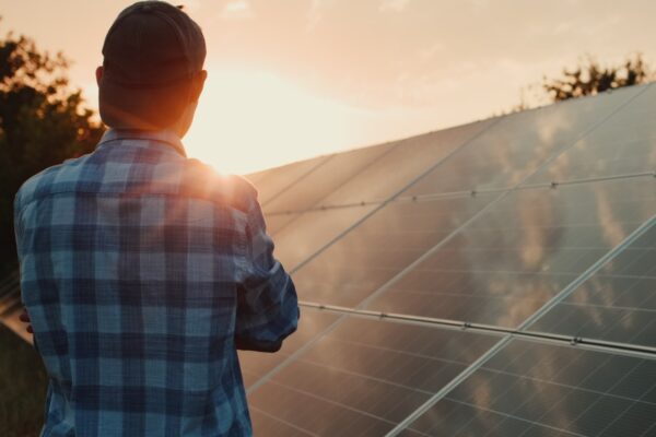 Man checking solar panel at sun set for net metering