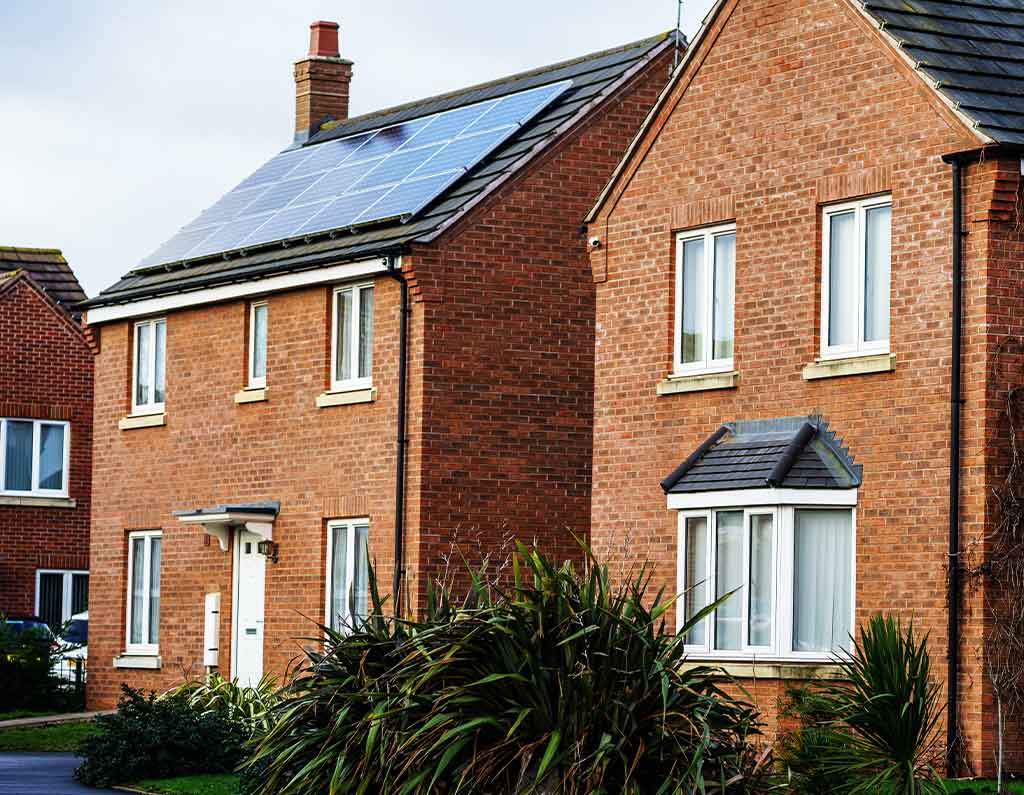 brick home with solar panels on roof