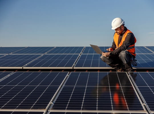 man using laptop while installing solar panels in Washington D.C.