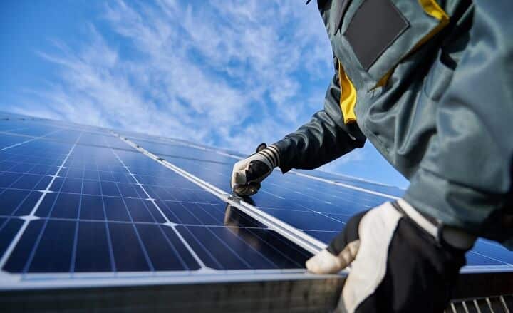 man cleaning the solar panels with tool