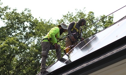 Solar installers on a roof of a Vienna VA home