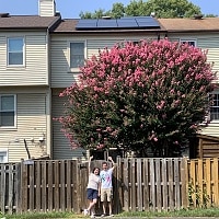 couple in front of vienna va townhome with new solar panels