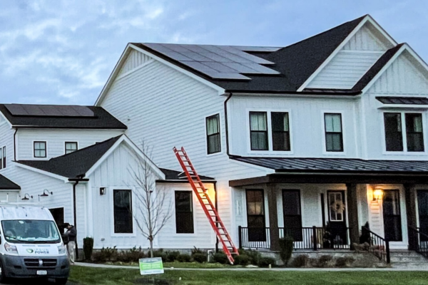 white two story home in virginia with solar panels installed across roof