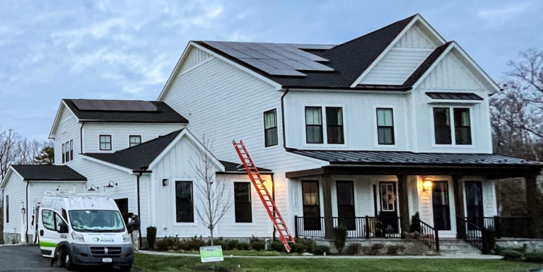 white two story home in virginia with solar panels installed across roof