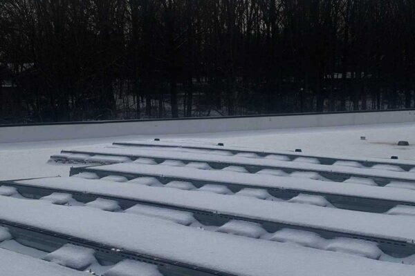 Solar panels covered in snow on roof